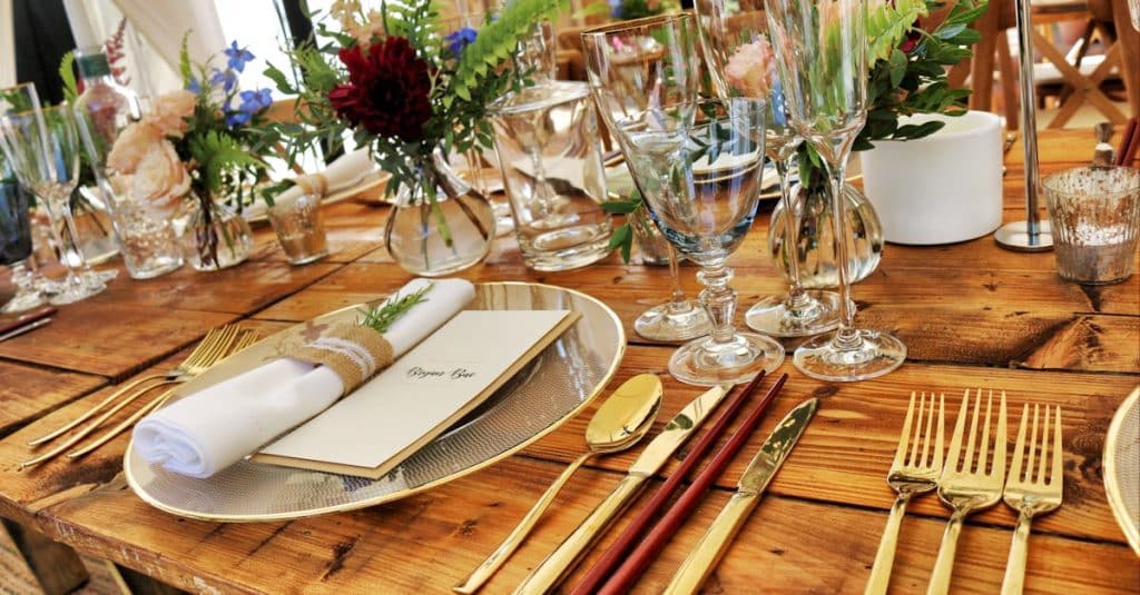 Beautifully arranged table with elegant cutlery and floral decoration, perfect for fine dining.